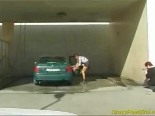 Crazy pee young woman at the car wash